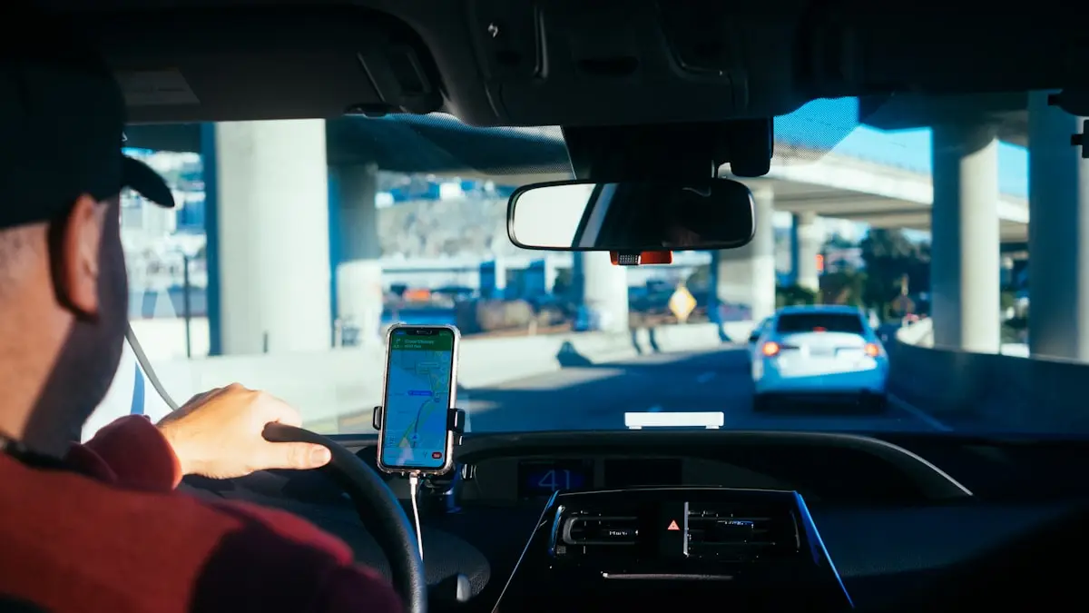 View over a driver's shoulder showing a phone mounted on the dashboard in traffic