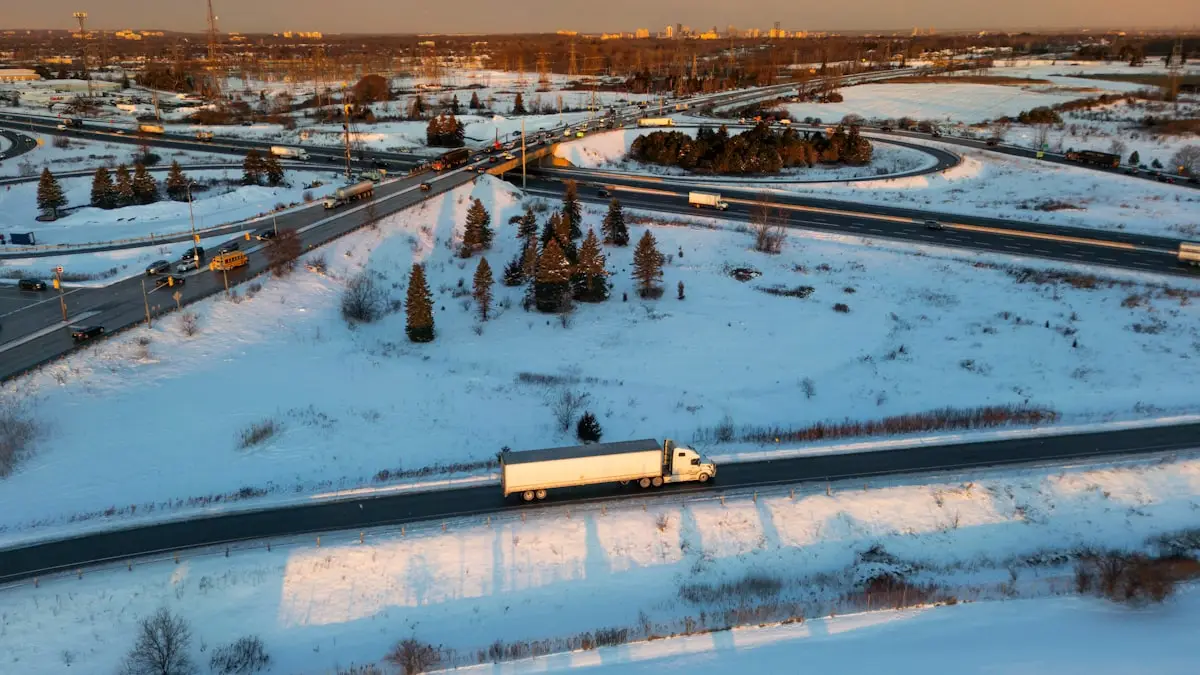 Aerial view of a semi truck on a snowy highway at dusk
